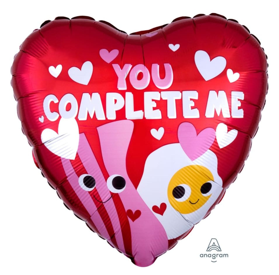 Heart-shaped balloon with emoji and text 'You Complete Me' 